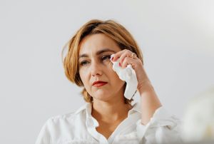 Woman with dry eyes watering