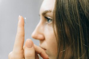 Woman putting a contact lens in her eye